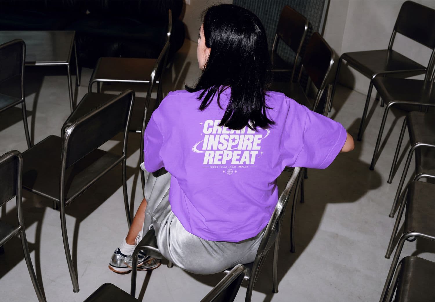 Purple T-Shirt Mockup on Woman from Rear Seated View