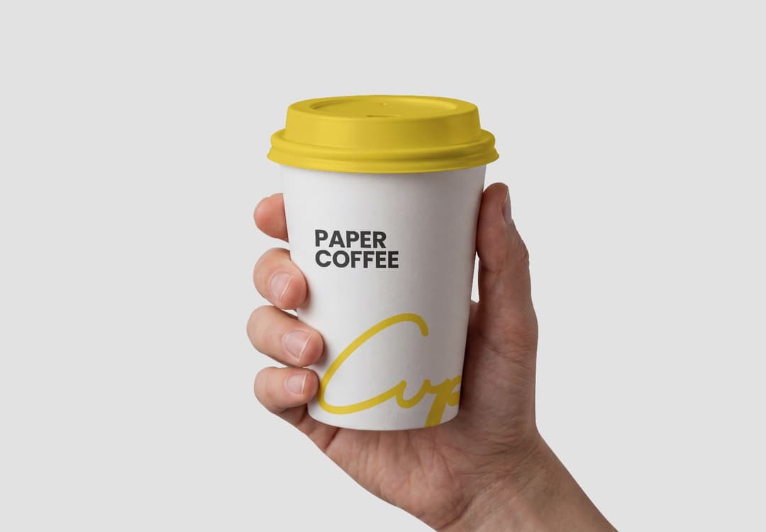 Hand Holding Design Paper Coffee Cup Mockup